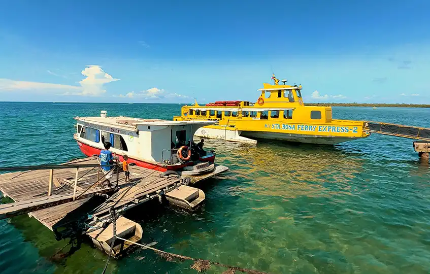 Small boat and Sta. Rosa Ferry Express docked at Angasil Port in Mactan, Cebu, heading to Olango Island